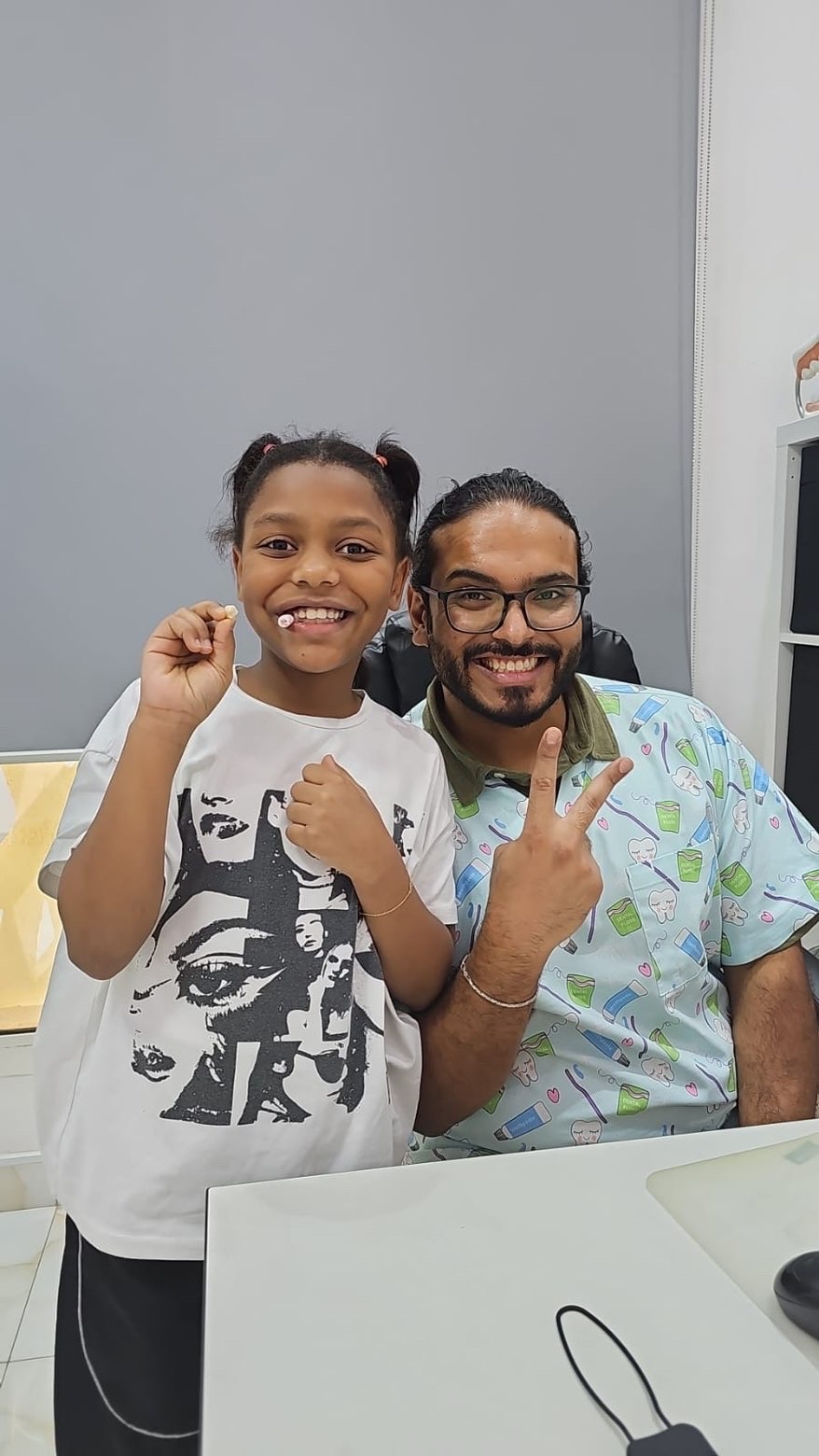Dr. Mohsen Alozaibi performing gentle dental treatment on a child